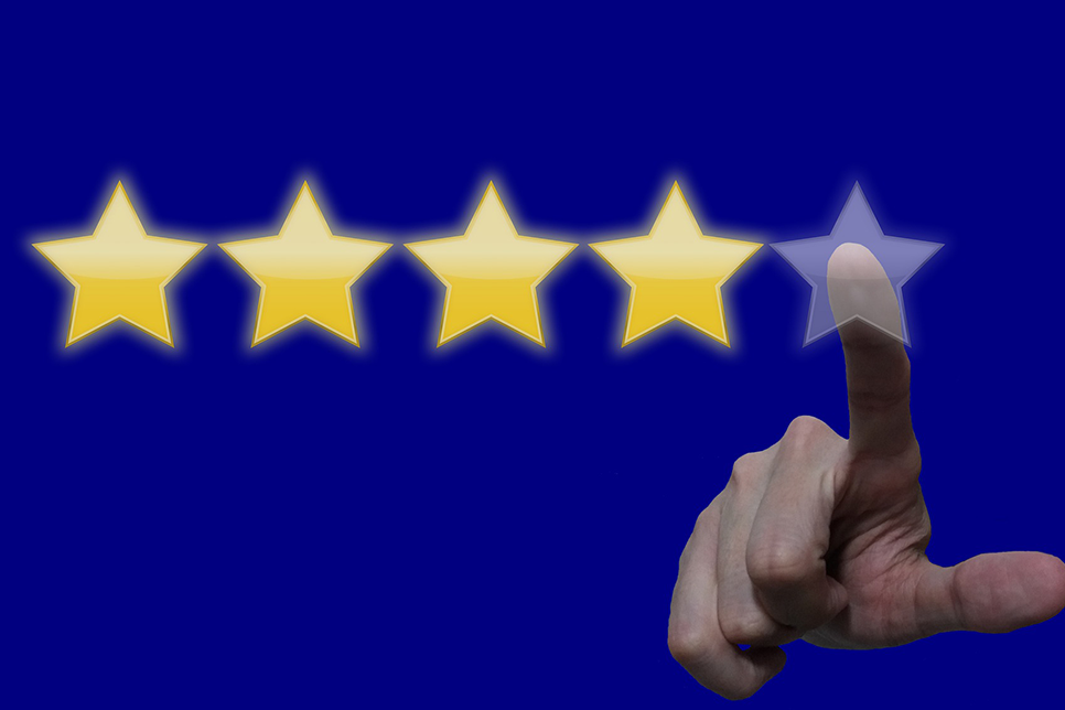 finger selecting stars to rate